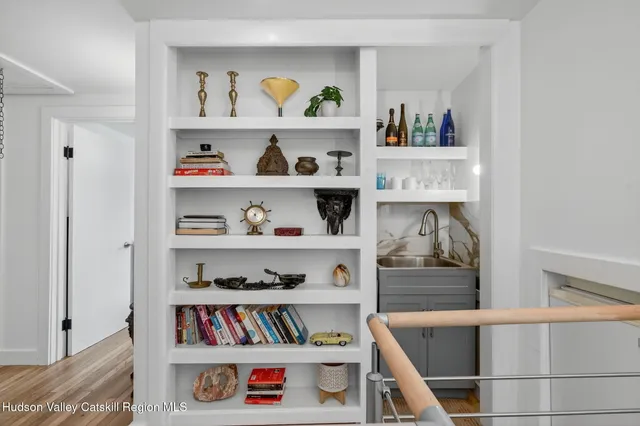a view of a bedroom with a bed and wooden floor