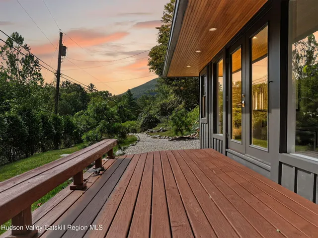a view of balcony with wooden floor and fence