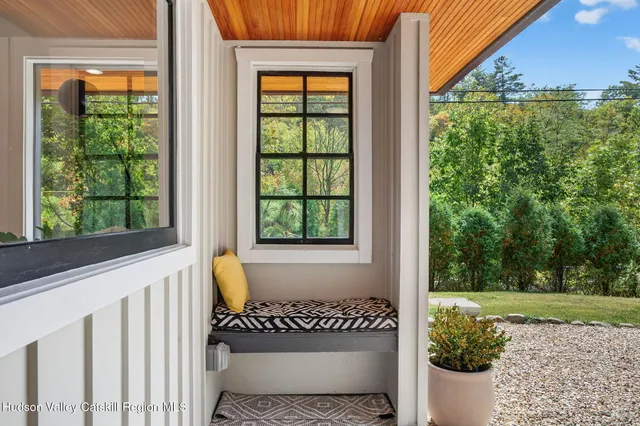 a living room with furniture large window and a fireplace