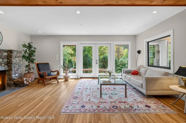 a bedroom with furniture and a large window