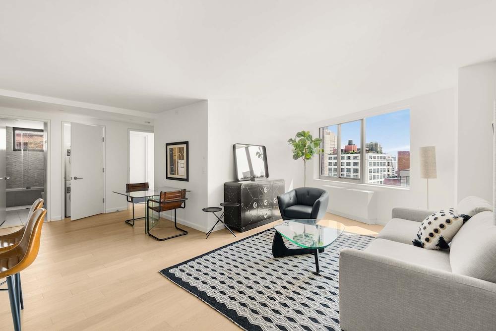 1 Union Square South, Unit 18R Manhattan, NY 10003 - Photo 2 of 10 a living room with furniture a rug and a window