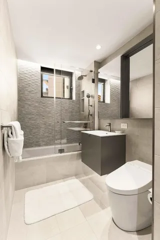 a bathroom with a sink a toilet and bathtub
