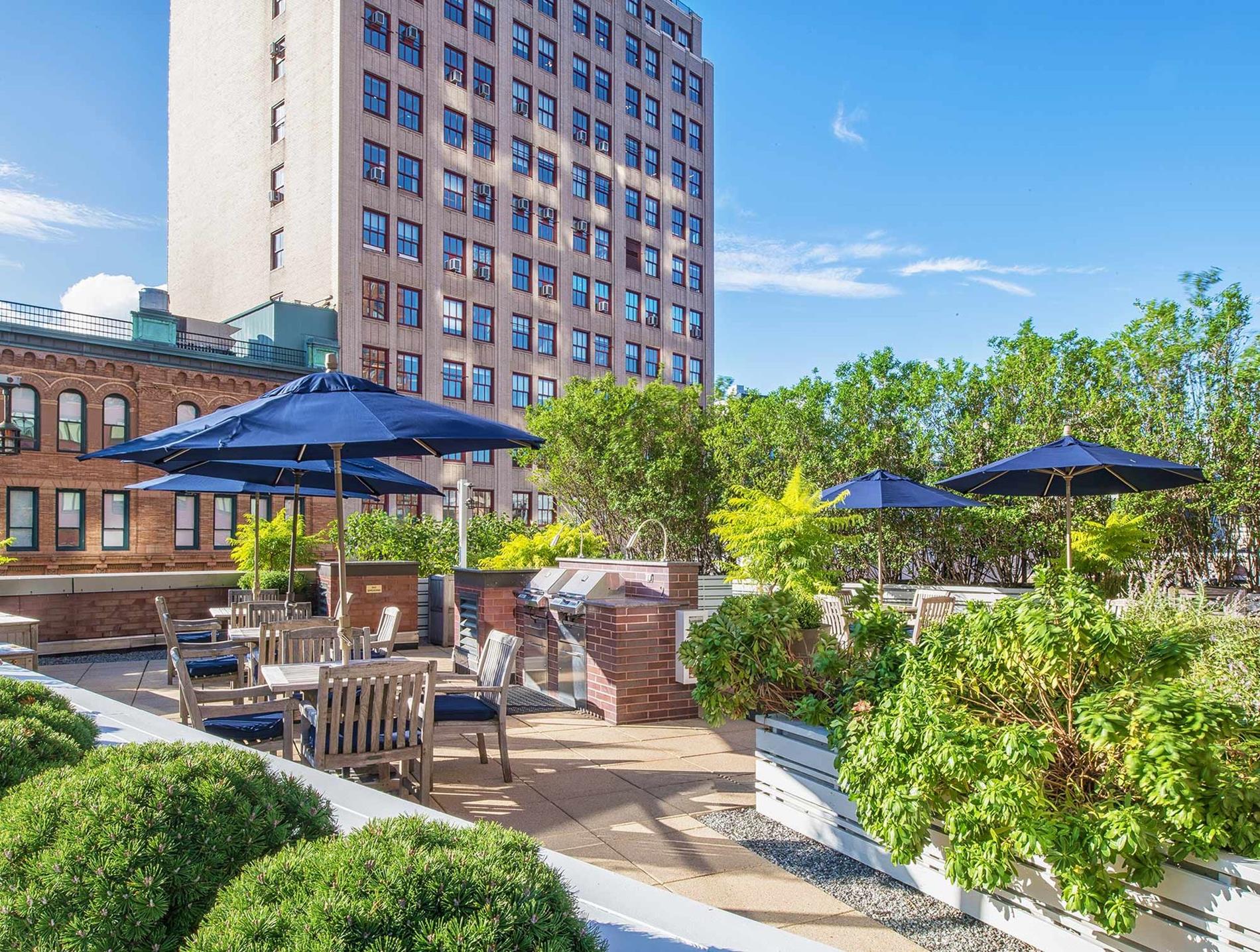 1 Union Square South, Unit 18R Manhattan, NY 10003 - Photo 8 of 10 a view of a patio with a table and chairs under an umbrella