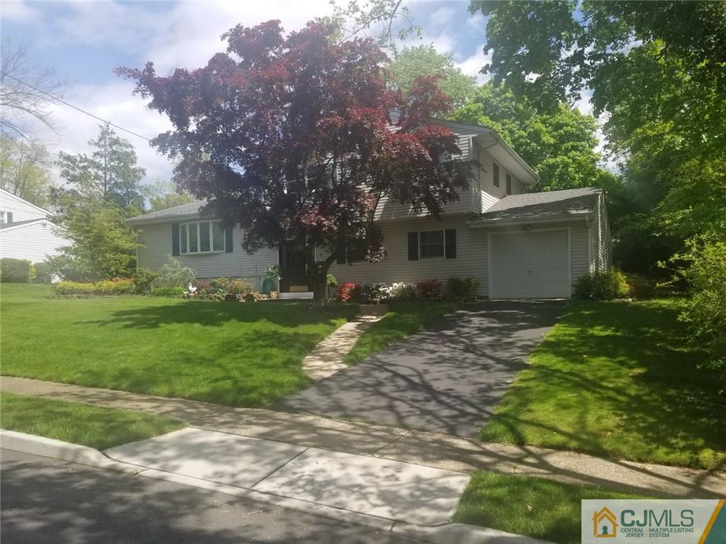 30 Agate Road East Brunswick, NJ 08816 - Photo 1 of 40 a backyard of a house with plants and large tree