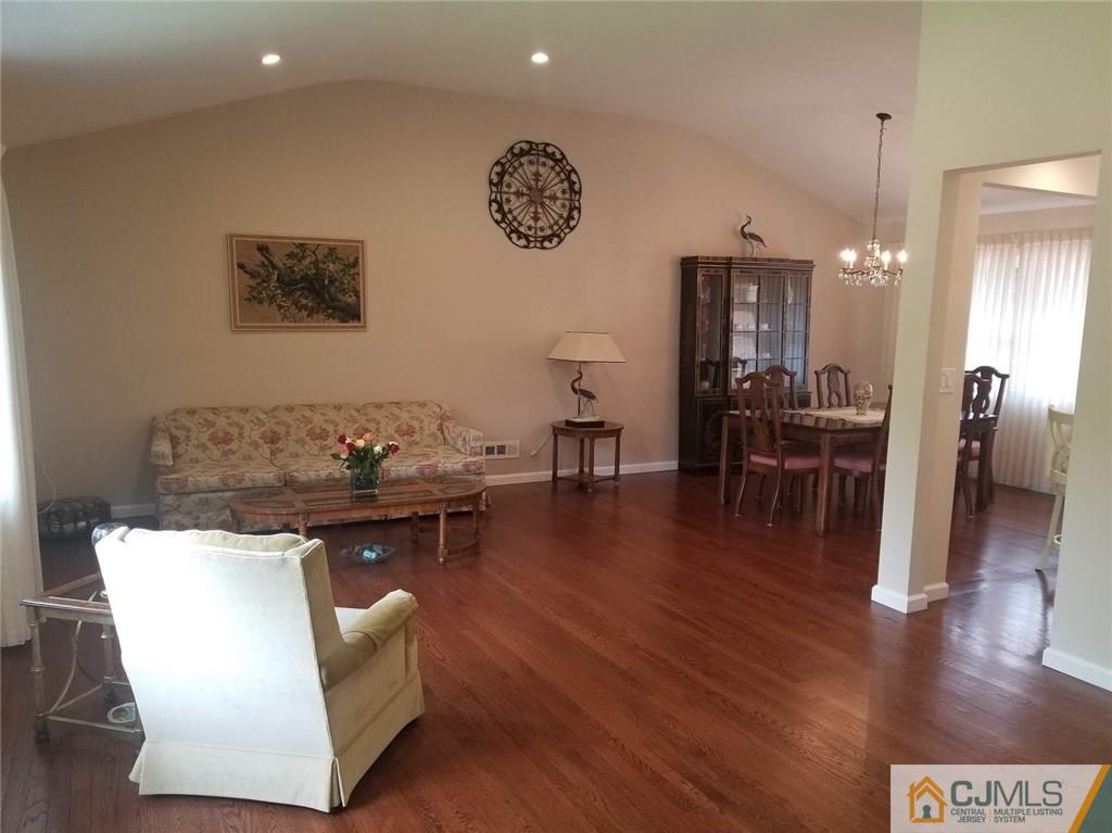 30 Agate Road East Brunswick, NJ 08816 - Photo 12 of 40 a living room with couches and painting on the wall with wooden floor