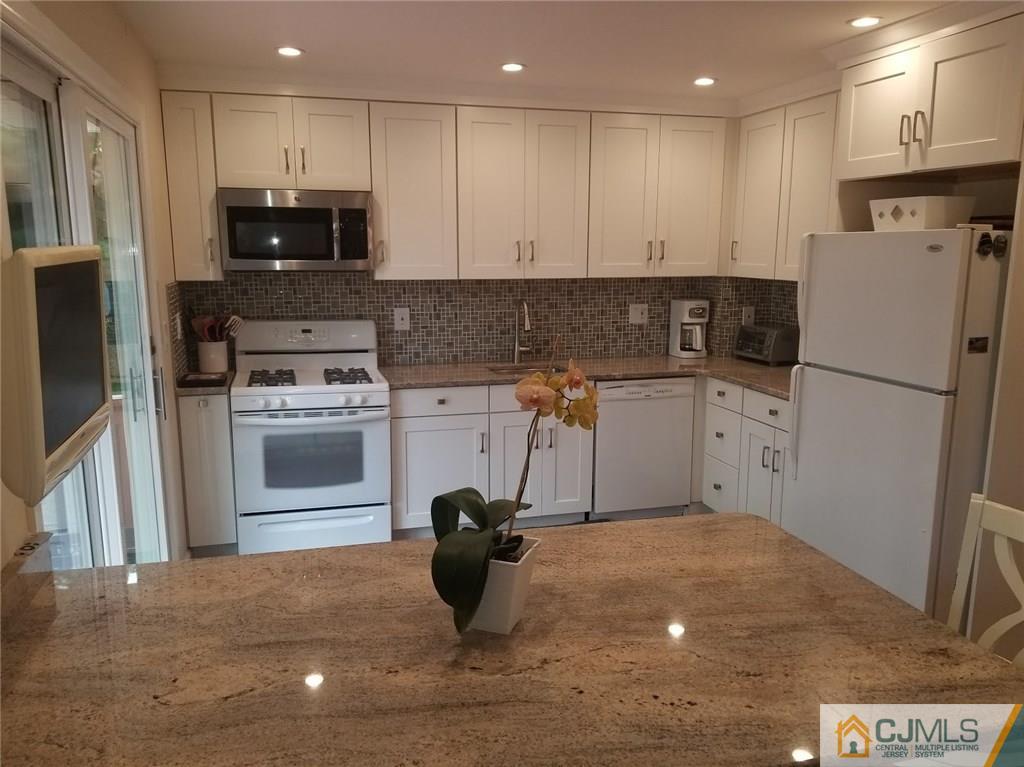 30 Agate Road East Brunswick, NJ 08816 - Photo 19 of 40 a kitchen with a refrigerator and a sink