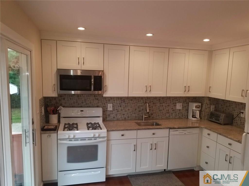 30 Agate Road East Brunswick, NJ 08816 - Photo 20 of 40 a kitchen with white cabinets stainless steel appliances and sink