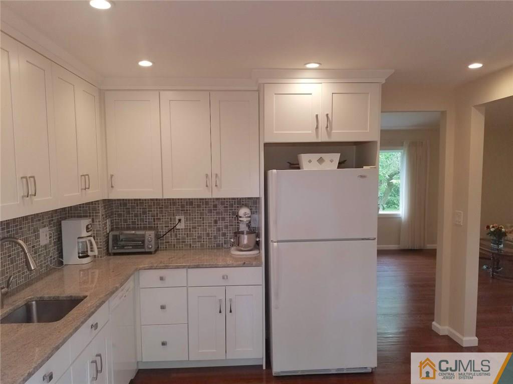 30 Agate Road East Brunswick, NJ 08816 - Photo 21 of 40 a kitchen with a refrigerator sink and cabinets