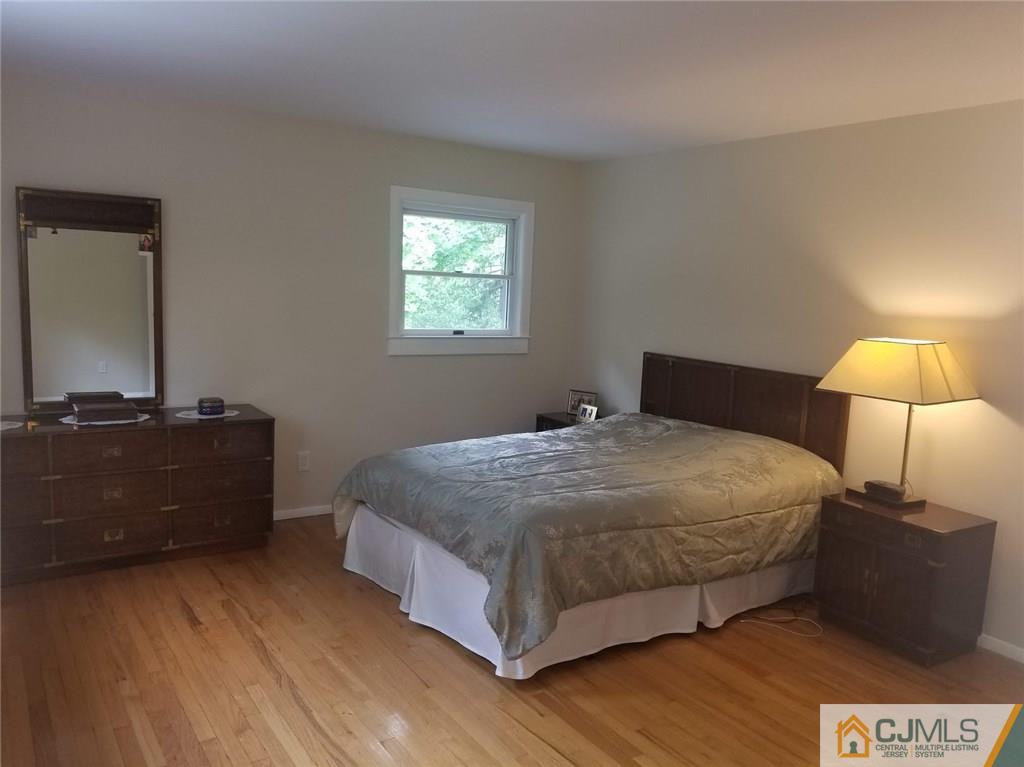 30 Agate Road East Brunswick, NJ 08816 - Photo 25 of 40 a bedroom with a bed and a lamp
