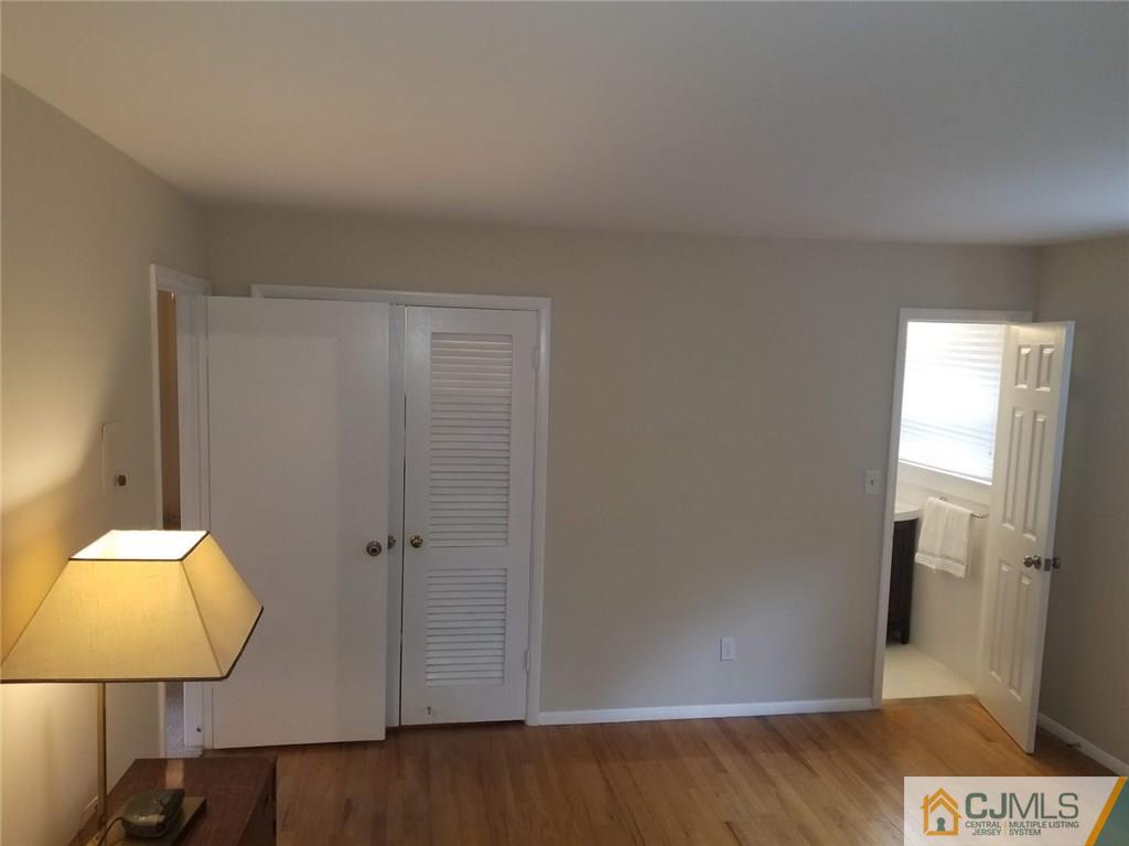 30 Agate Road East Brunswick, NJ 08816 - Photo 26 of 40 wooden floor in an empty room with a mirror