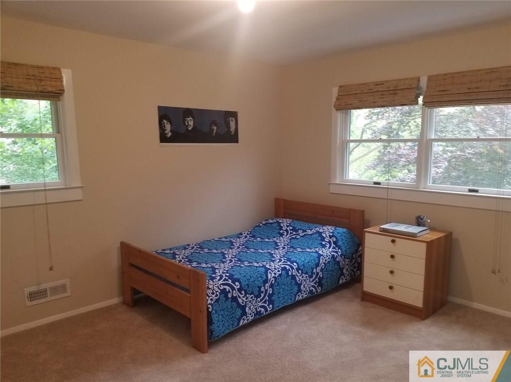 30 Agate Road East Brunswick, NJ 08816 - Photo 30 of 40 a bed sitting in a bedroom next to a window