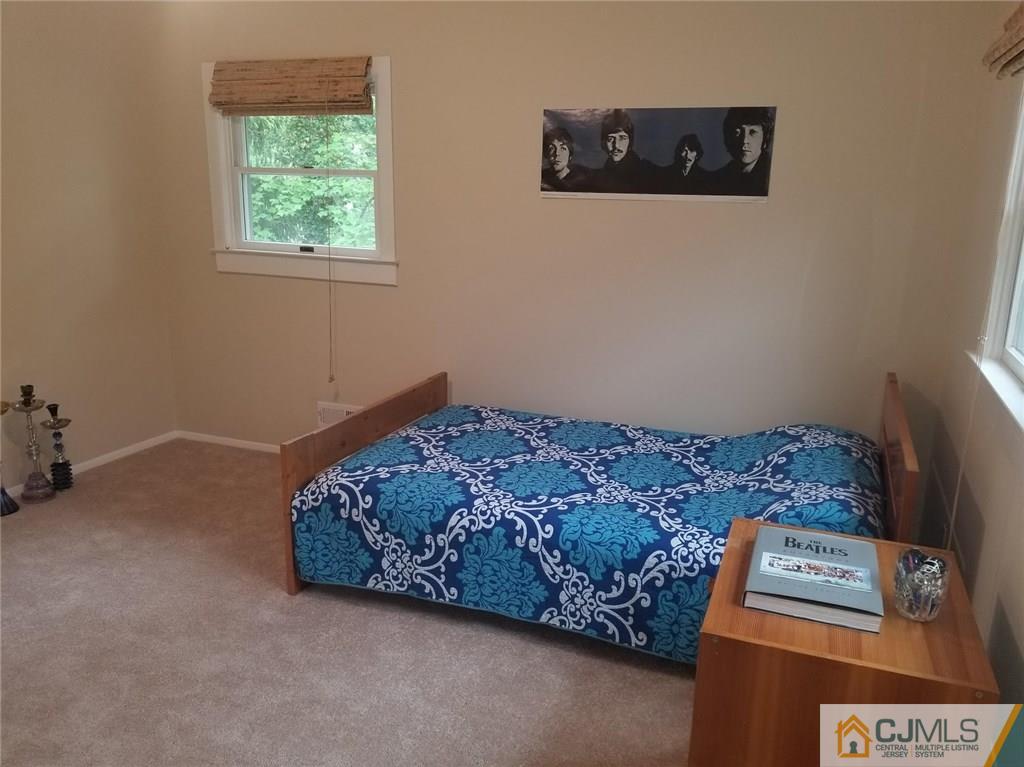 30 Agate Road East Brunswick, NJ 08816 - Photo 31 of 40 a bed room with a bed and a tv