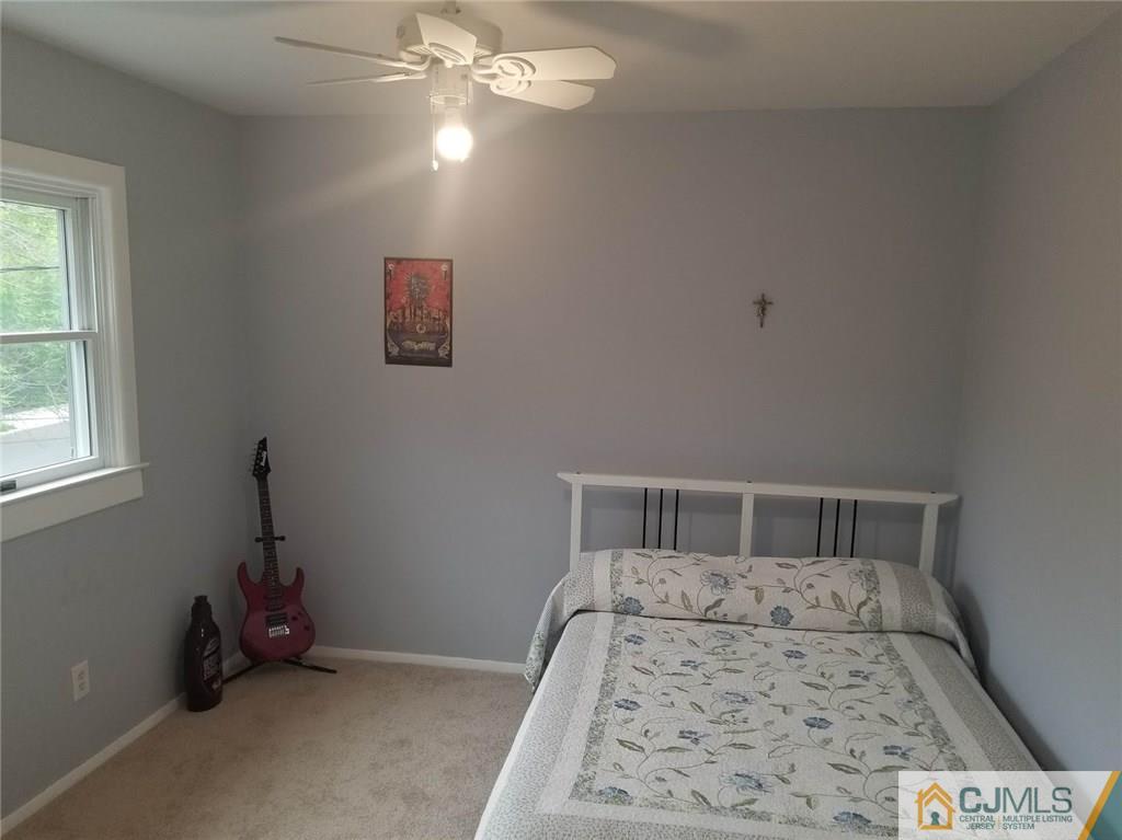 30 Agate Road East Brunswick, NJ 08816 - Photo 34 of 40 a bedroom with a bed and wooden floor