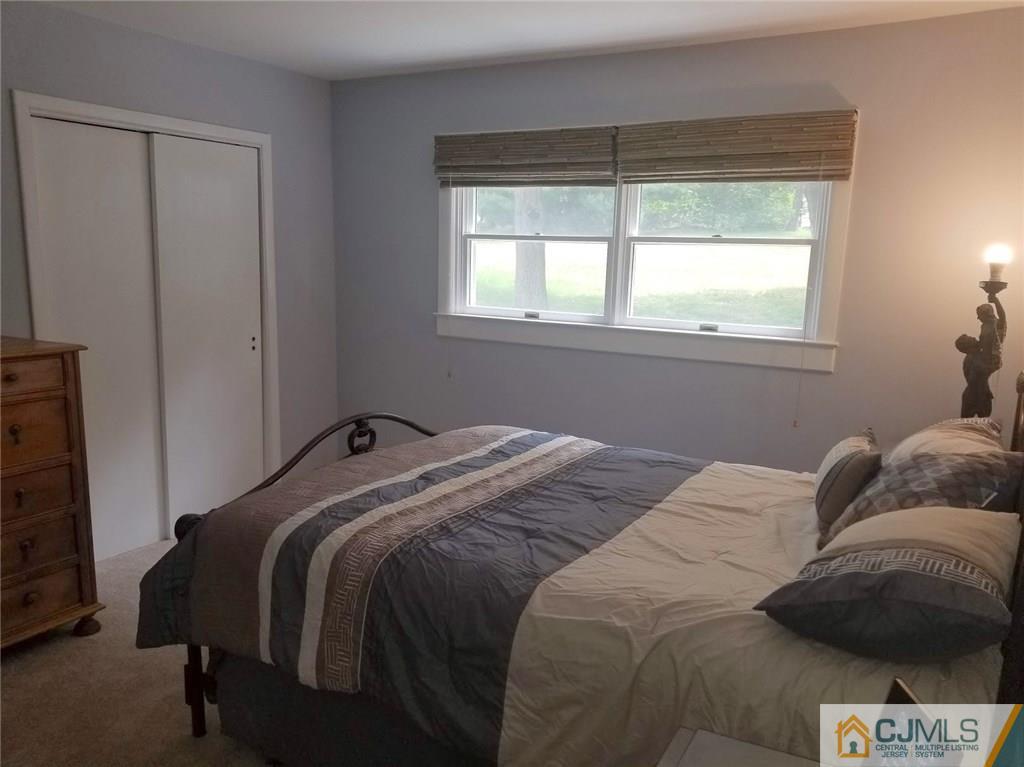 30 Agate Road East Brunswick, NJ 08816 - Photo 9 of 40 a bed sitting in a bedroom next to a window