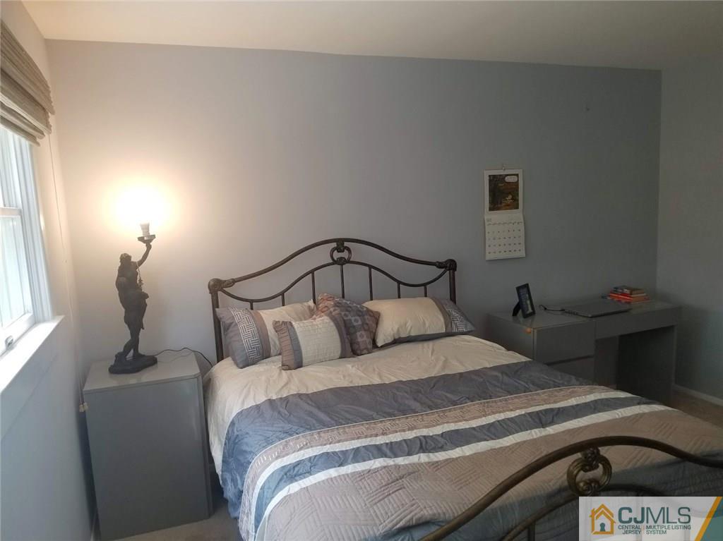 30 Agate Road East Brunswick, NJ 08816 - Photo 10 of 40 a bedroom with a bed and window