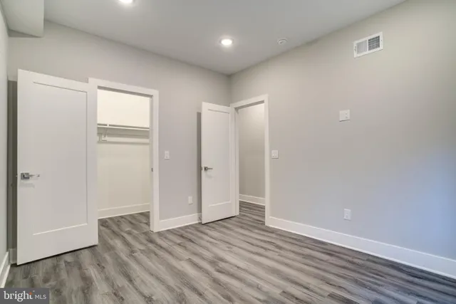 a view of an empty room with wooden floor