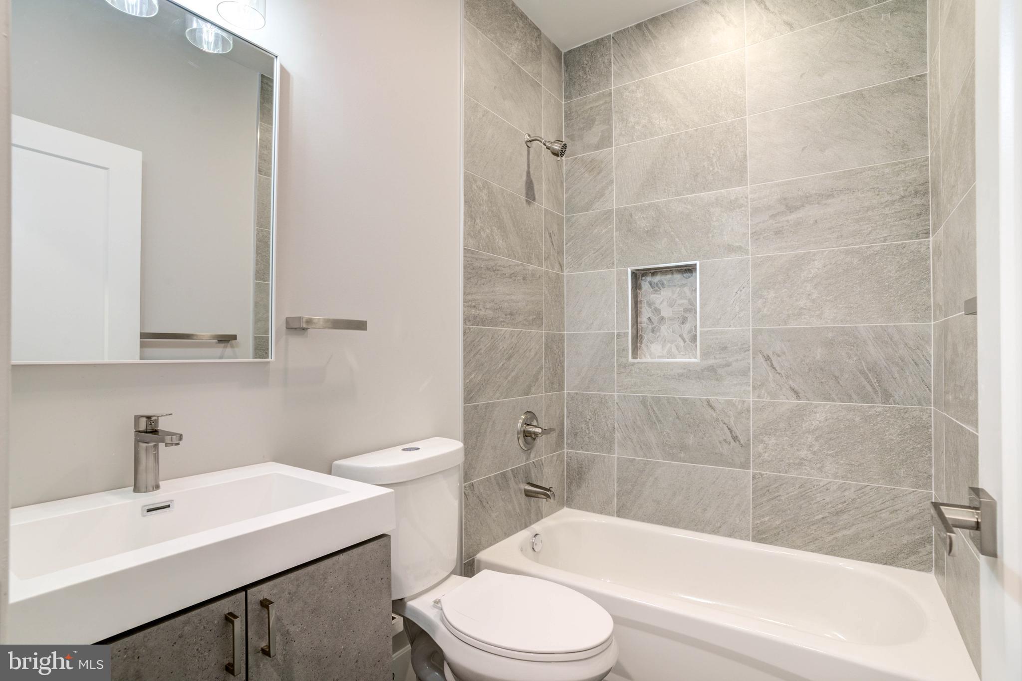 5005 Walnut Street Philadelphia, PA 19139 - Photo 23 of 39 a bathroom with a sink toilet and shower