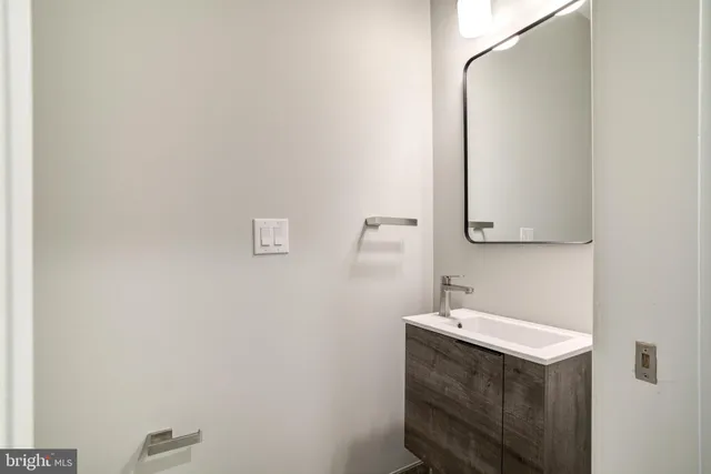a bathroom with a sink a vanity and a mirror