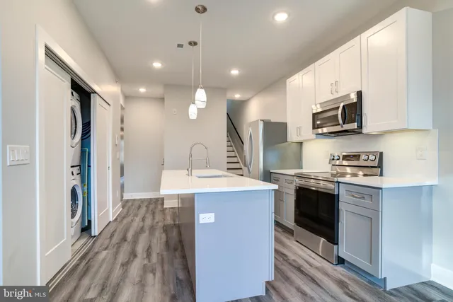 a kitchen with stainless steel appliances granite countertop a stove and a sink