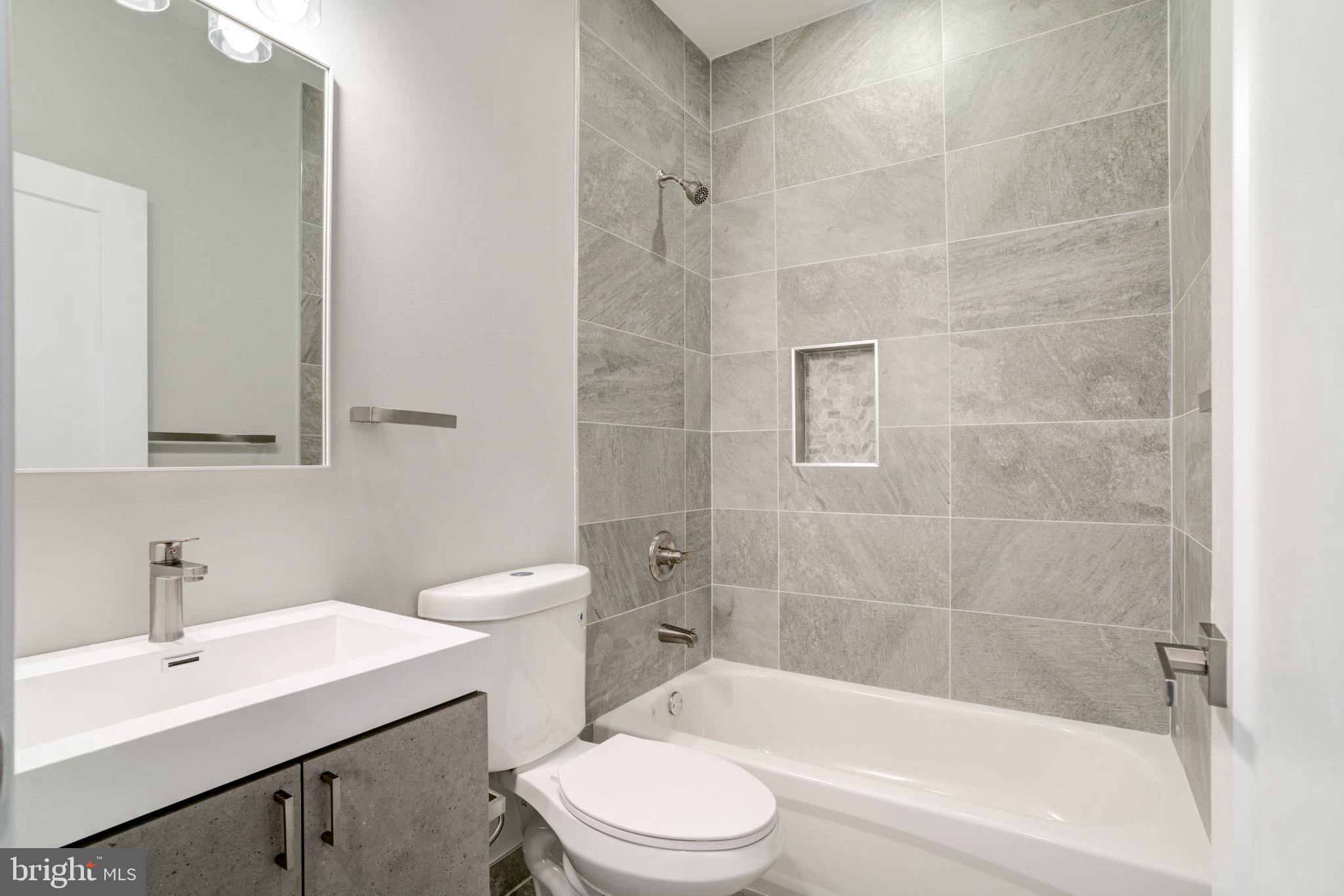5005 Walnut Street Philadelphia, PA 19139 - Photo 33 of 39 a bathroom with a sink a toilet and shower