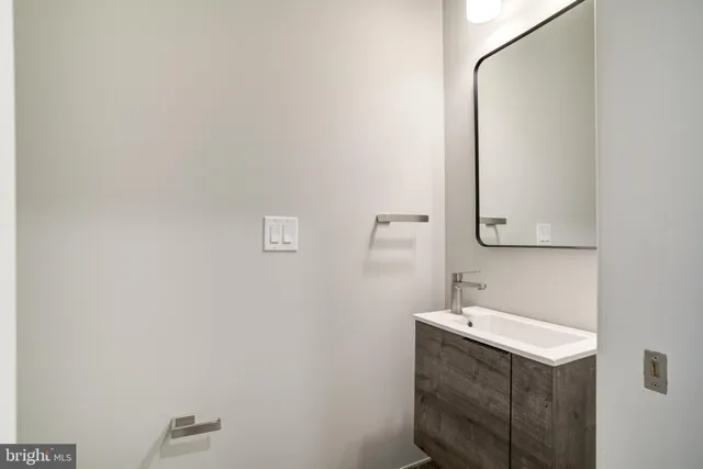 a bathroom with a sink vanity and mirror