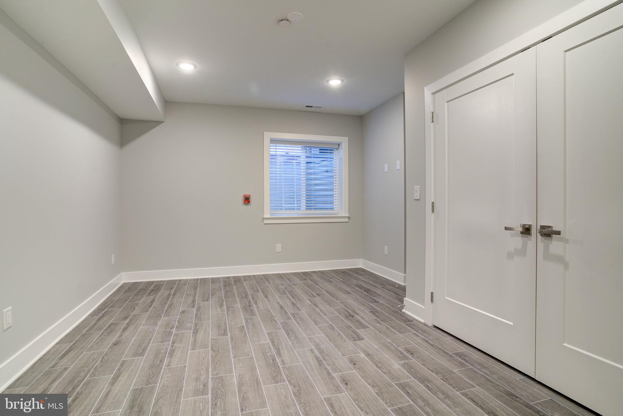 5005 Walnut Street Philadelphia, PA 19139 - Photo 7 of 39 a view of an empty room with wooden floor and a window