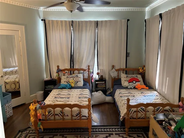 a bedroom with bed and a mirror