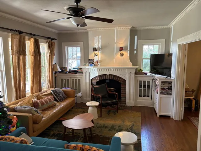 a living room with furniture a fireplace and a flat screen tv