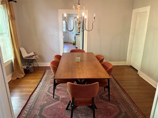 a dining room with furniture and wooden floor