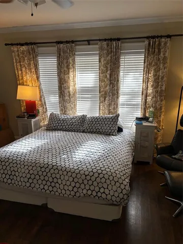 a bed sitting in a bedroom next to a window