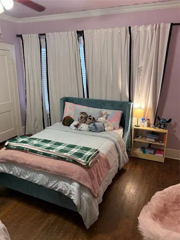 a bedroom with a bed and a mirror