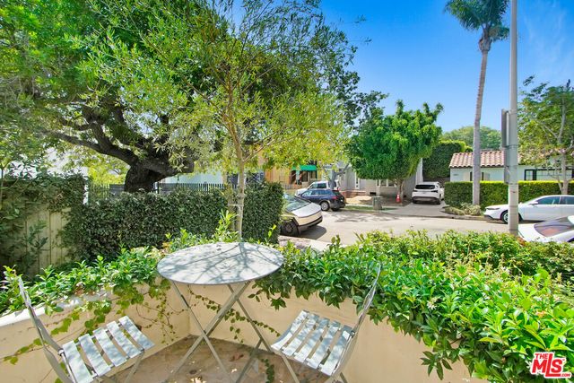 a view of a table and chairs in backyard of the house