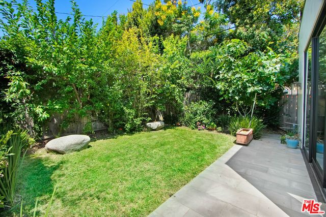 a view of a table and chairs in the garden
