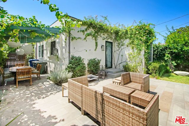 a view of a patio with table and chairs and potted plants
