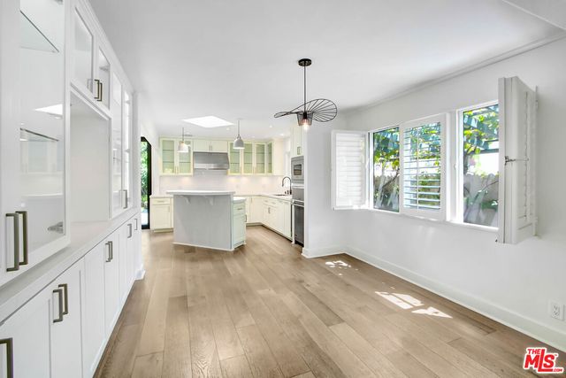 a view of a kitchen with a sink wooden floor and windows