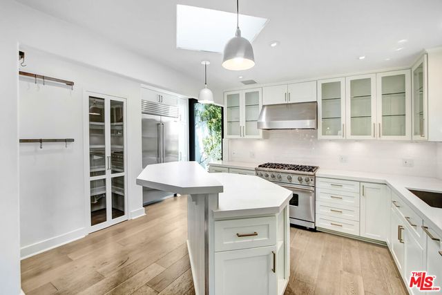 a kitchen with a stove a sink and a refrigerator