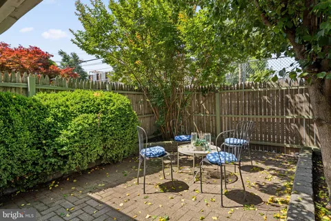 a view of a chairs and table in backyard