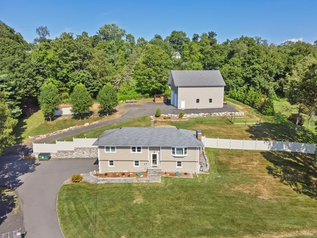 an aerial view of a house with yard swimming pool and outdoor seating