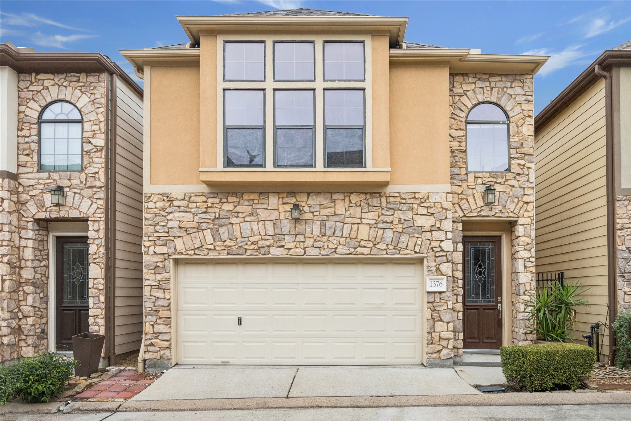 a front view of a house with large windows