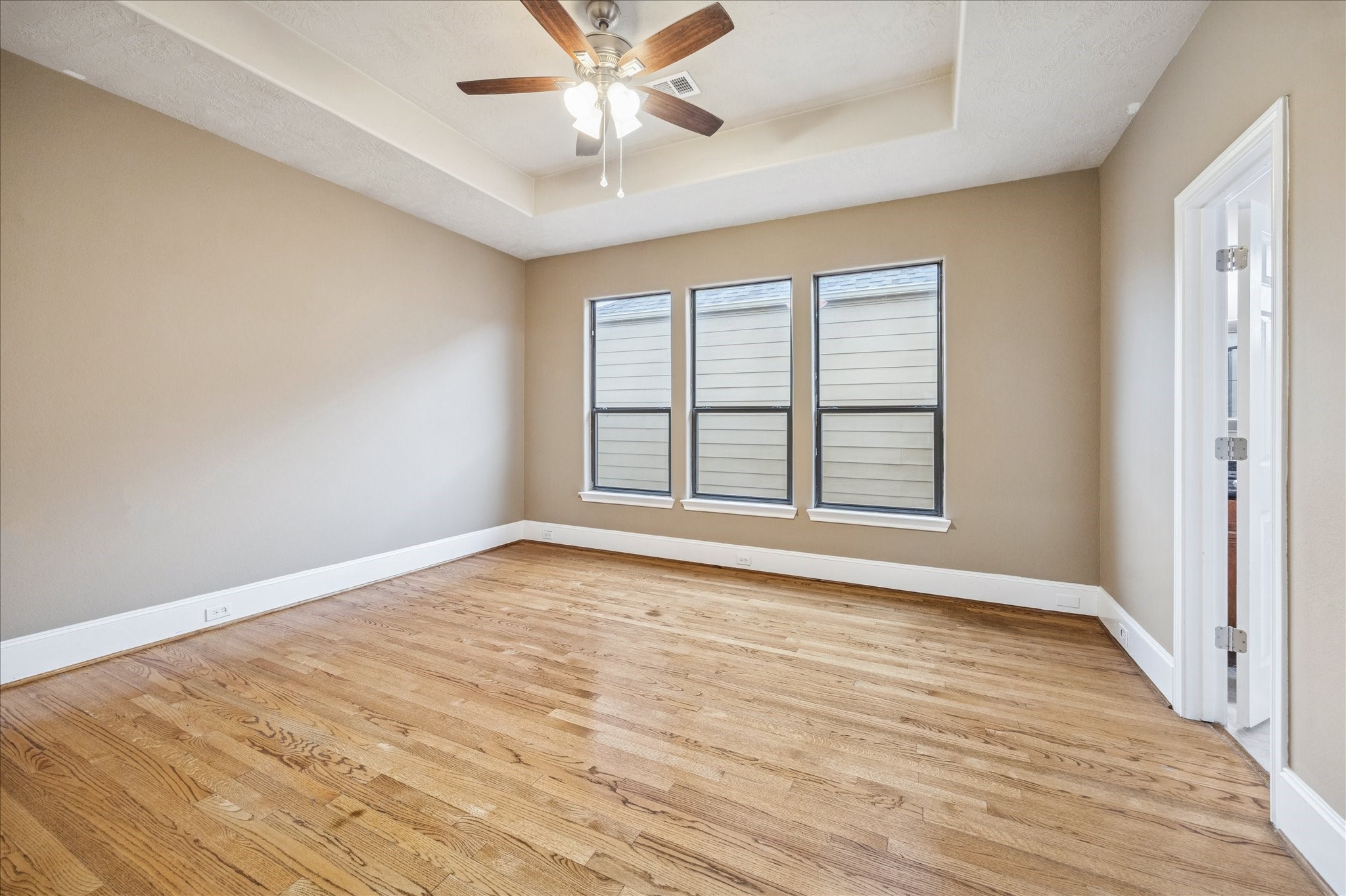 1376 Studer Street Houston, TX 77007 - Photo 15 of 38 a view of an empty room with wooden floor and a window