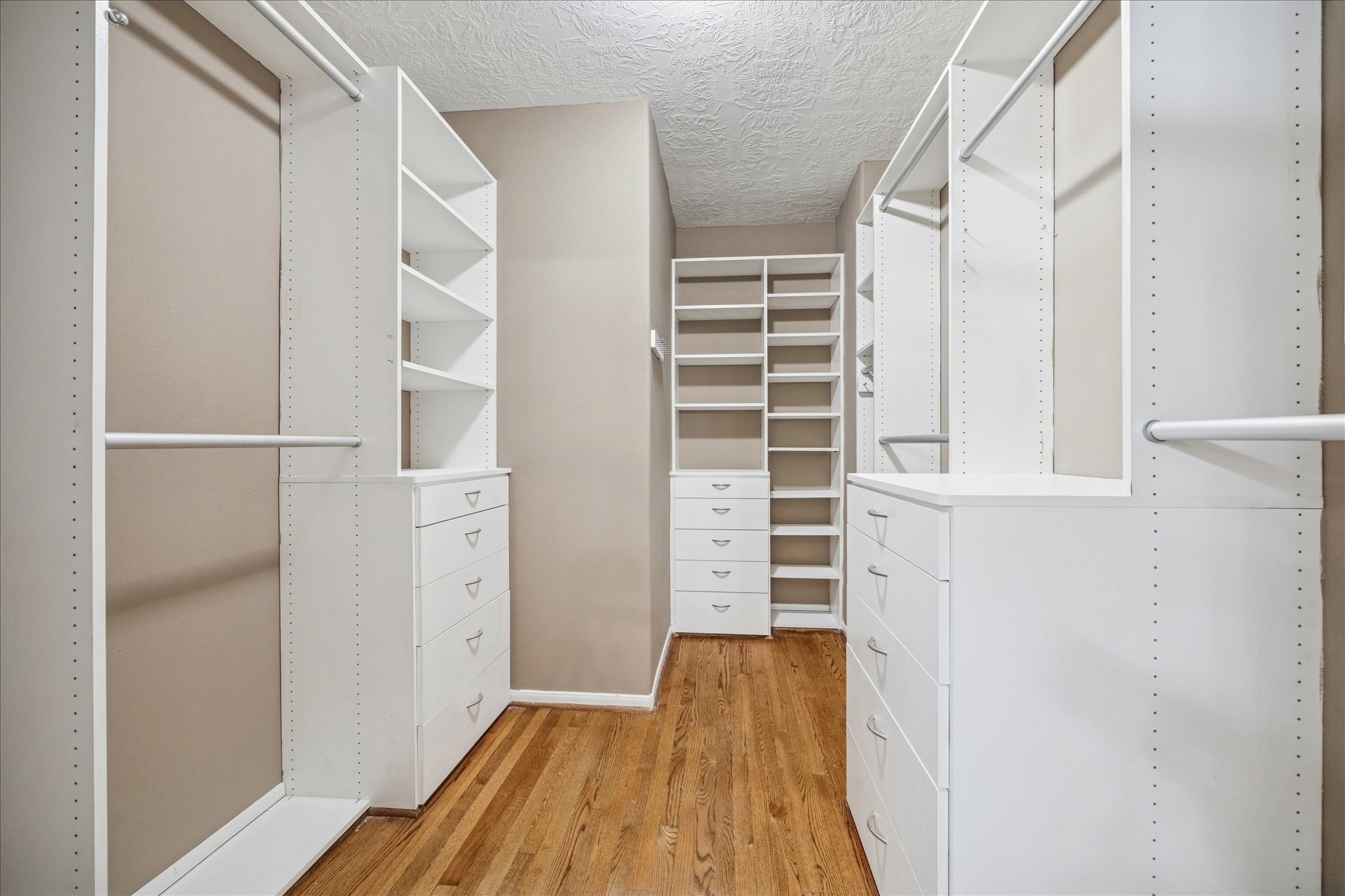 1376 Studer Street Houston, TX 77007 - Photo 19 of 38 a view of walk in closet with empty racks