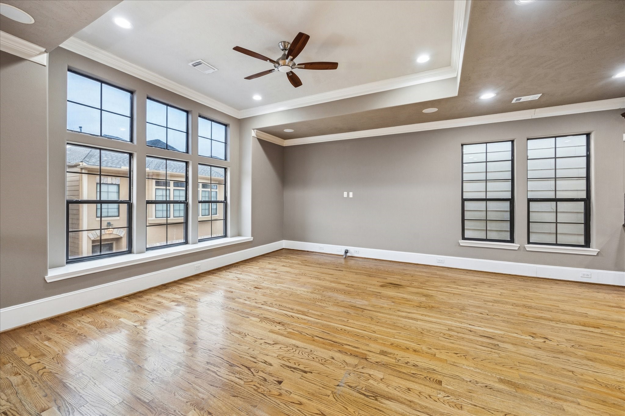 1376 Studer Street Houston, TX 77007 - Photo 5 of 38 a view of an empty room with a window and wooden floor