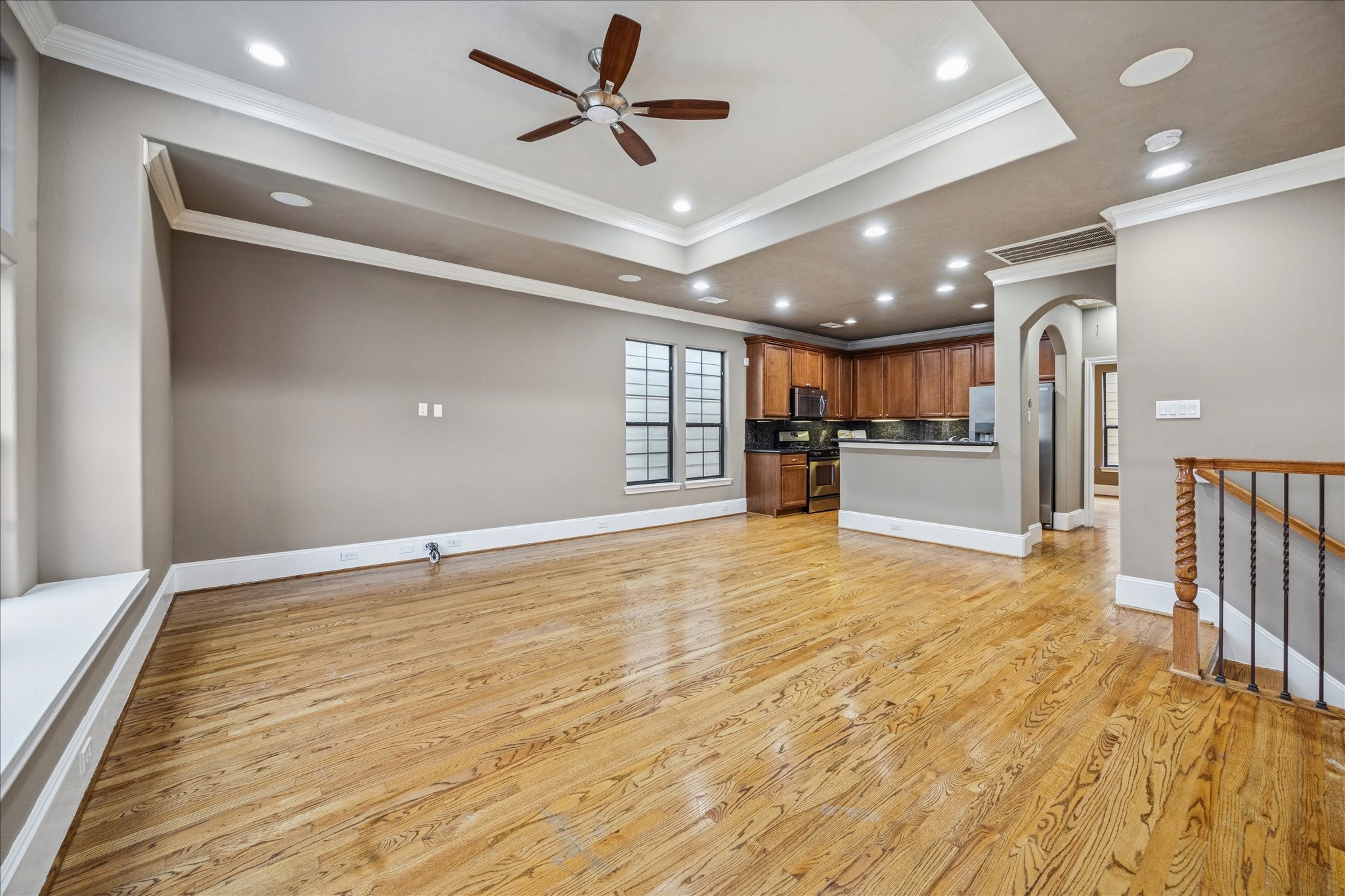 1376 Studer Street Houston, TX 77007 - Photo 8 of 38 a view of an empty room with wooden floor and a ceiling fan