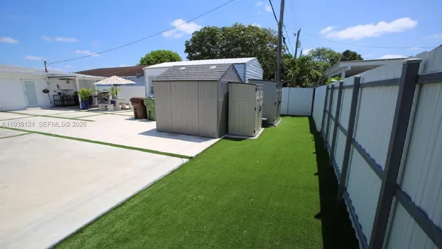 a patio with a table and chairs under an umbrella