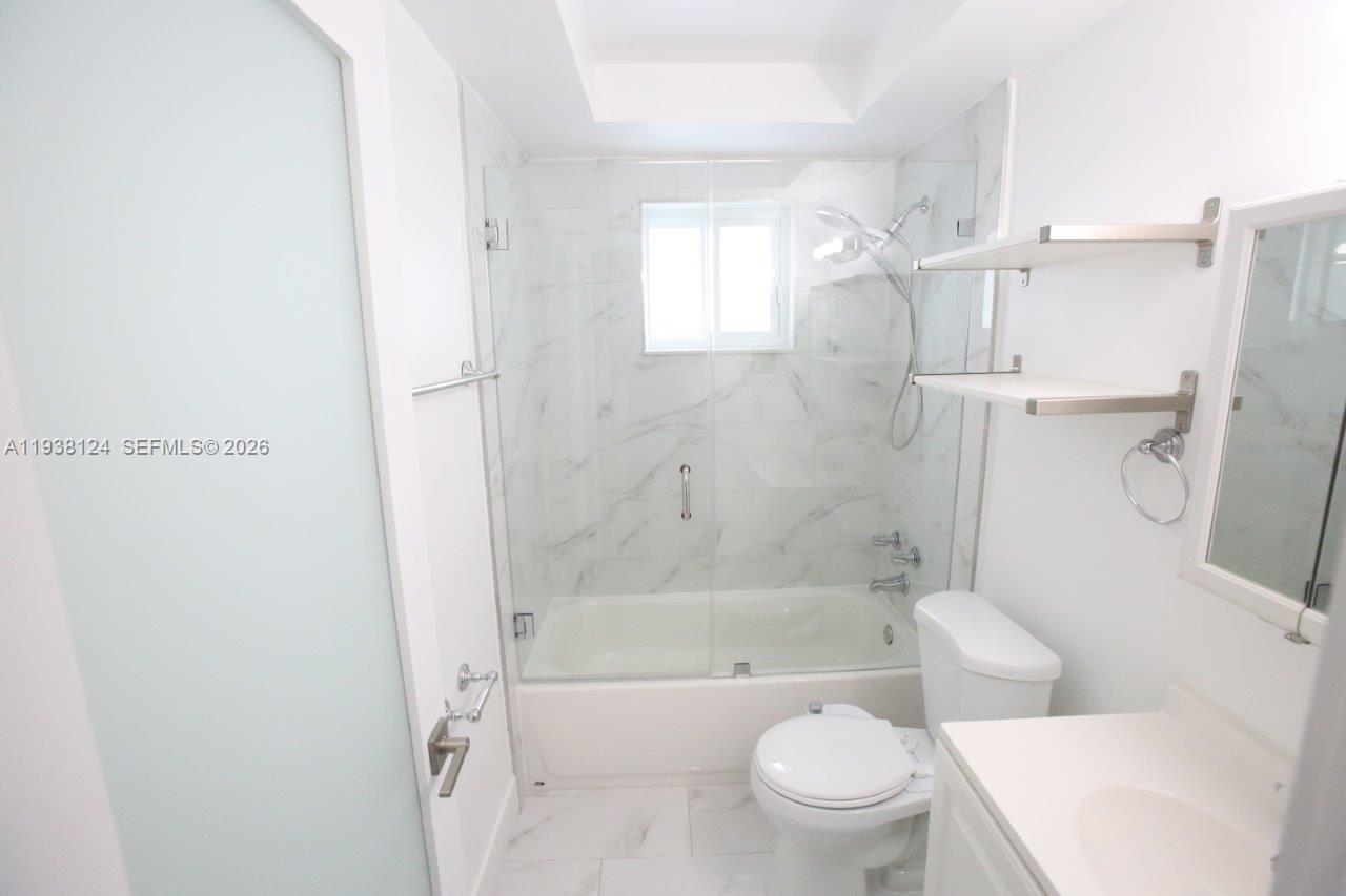 798 West 31st Street Hialeah, FL 33012 - Photo 7 of 15 a bathroom with a toilet and a bath tub