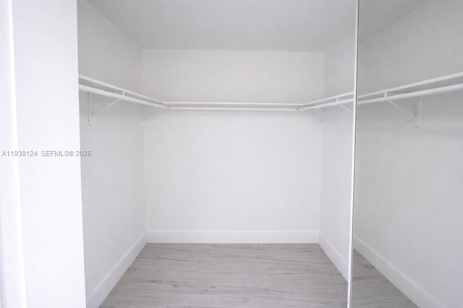 798 West 31st Street Hialeah, FL 33012 - Photo 9 of 15 a view of an empty walk in closet with wooden floor