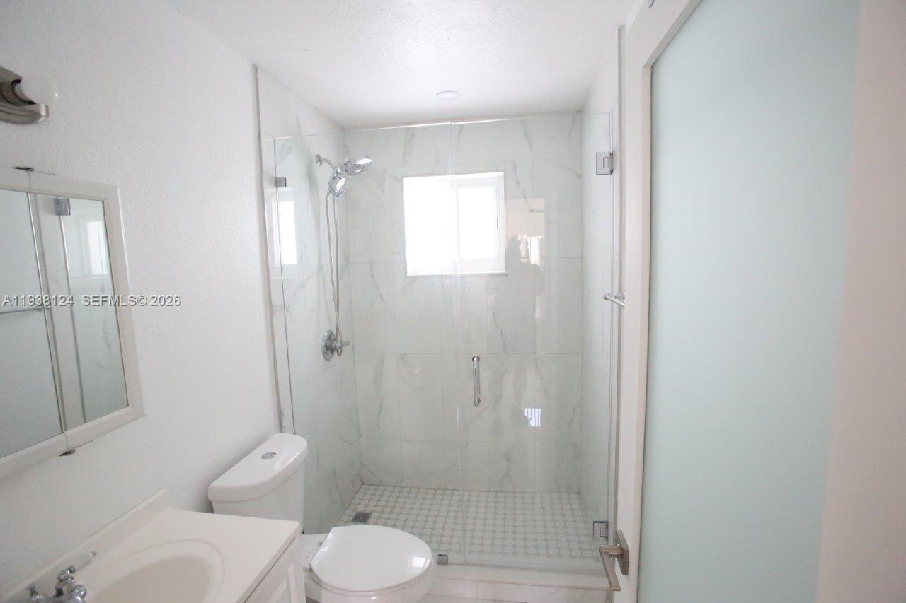798 West 31st Street Hialeah, FL 33012 - Photo 10 of 15 a bathroom with a shower and a toilet