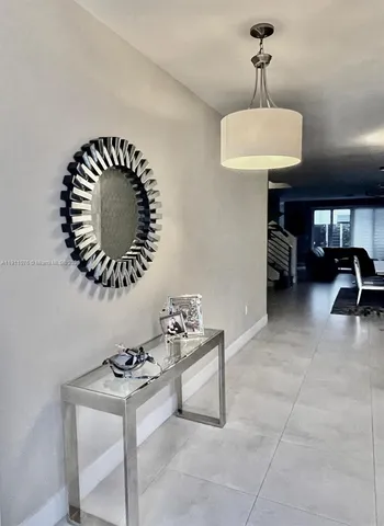 a room with a sink and a chandelier