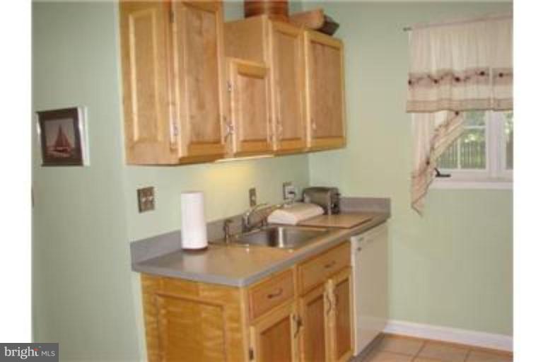612 Anneslie Road Baltimore, MD 21212 - Photo 10 of 19 a kitchen with a sink a cabinets and wooden floor