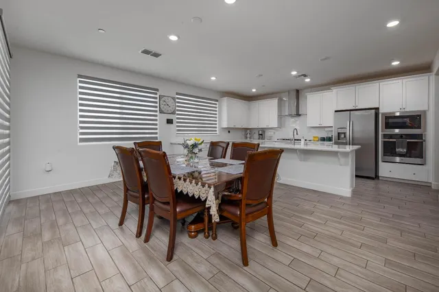 a kitchen with stainless steel appliances granite countertop white cabinets and a stove